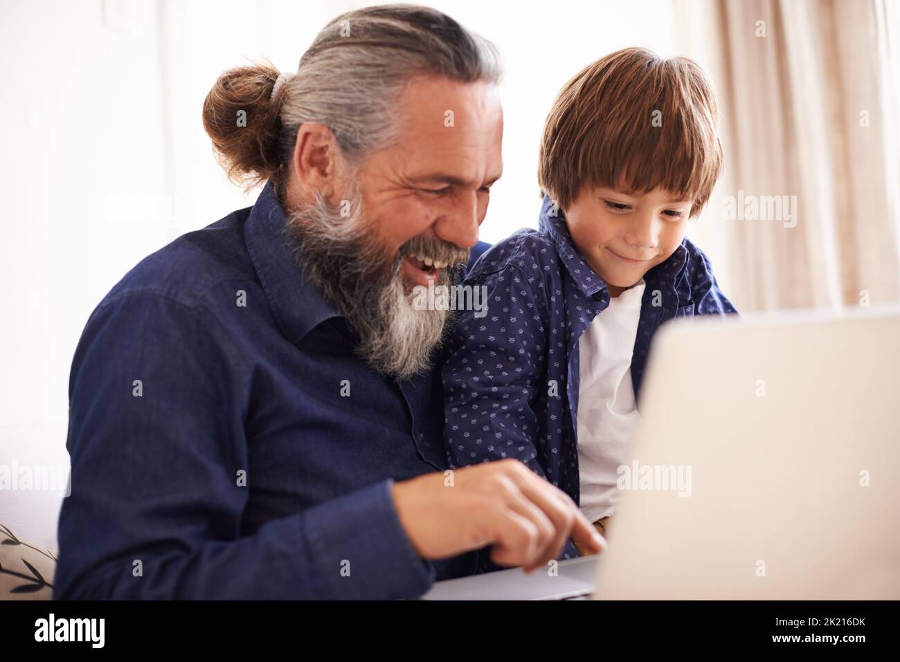 Helping grandpa set up his new laptop. a grandfather and grandson using ...