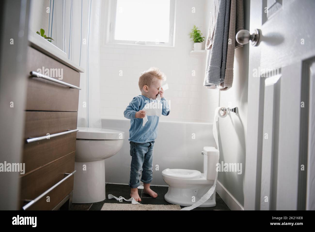 Boy blowing nose on toilet paper Stock Photo Alamy