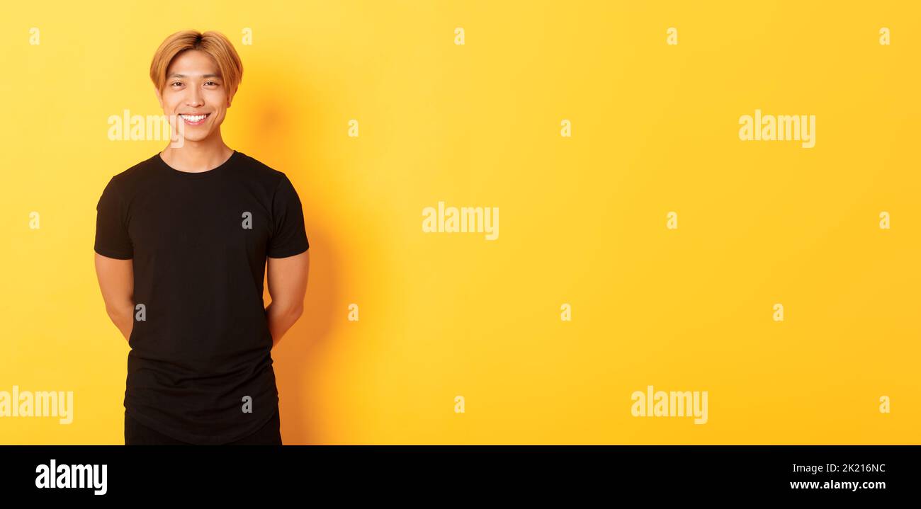 Portrait of friendly handsome asian guy with blond hair, smiling ...