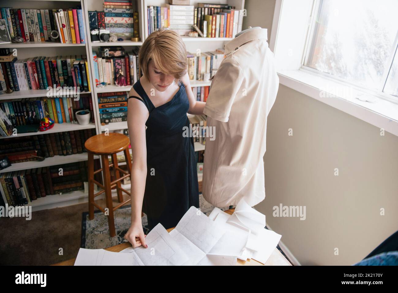 Young woman making clothes using mannequin Stock Photo Alamy