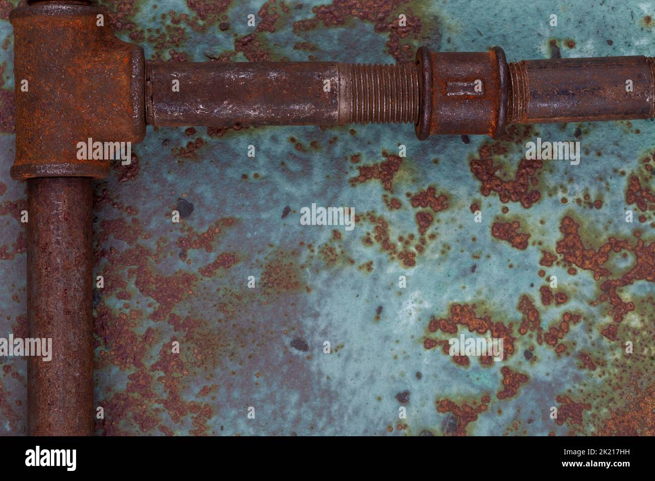 Old rusty valve pipes on rusty metal wall background Stock Photo - Alamy