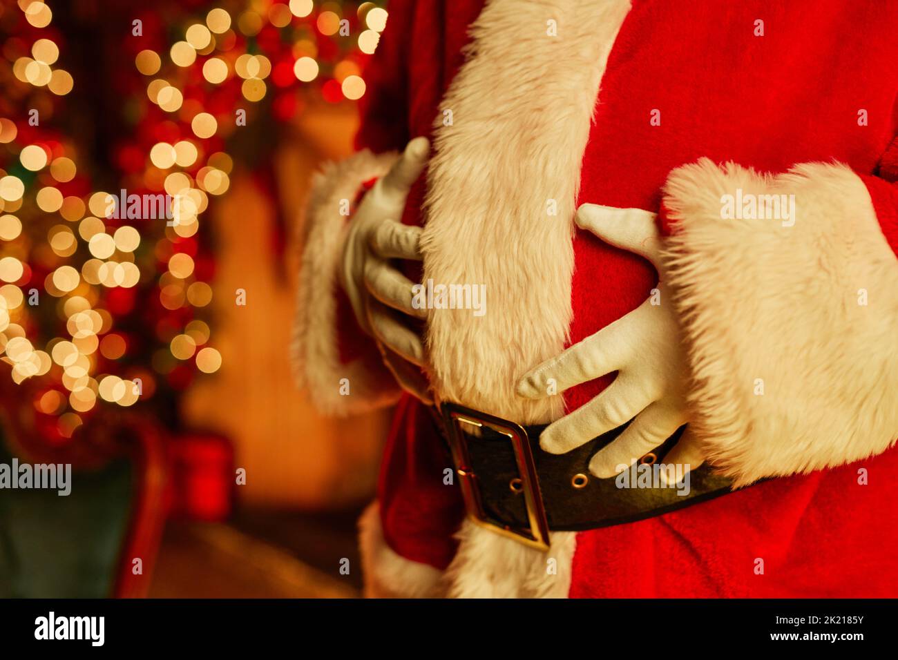 Christmas background image with unrecognizable Santa Claus wearing red suit, copy space Stock Photo