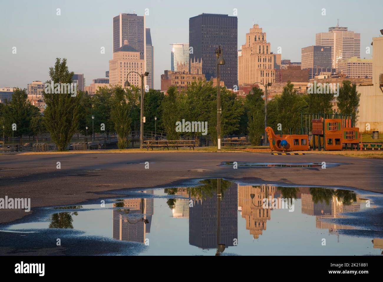 Montreal skyline reflected in puddle of rainwater in Old Port of Montreal, Quebec, Canada Stock Photo