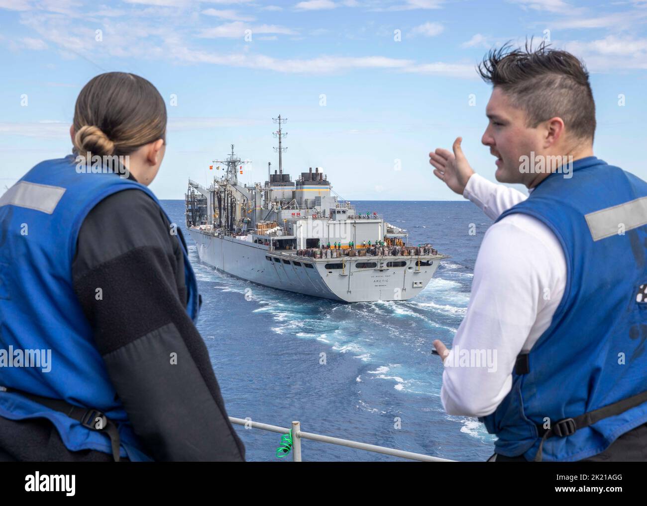 220920-N-ZG822-1050 ADRIATIC SEA (Sept. 20 2022) Quartermaster 3rd Class Jacob Renfrow, right, and Quartermaster Seaman Alexis Mitchell, both assigned to the Nimitz-class aircraft carrier USS George H.W. Bush (CVN 77), discuss the distance during the approach to the supply-class fast combat support ship USNS Arctic (T-AOE 8) for a replenishment-at-sea, Sept. 20, 2022. The George H.W. Bush Carrier Strike Group is on a scheduled deployment in the U.S. Naval Forces Europe area of operations, employed by U.S. Sixth Fleet to defend U.S., allied and partner interests. (U.S. Navy photo by Mass Commun Stock Photo