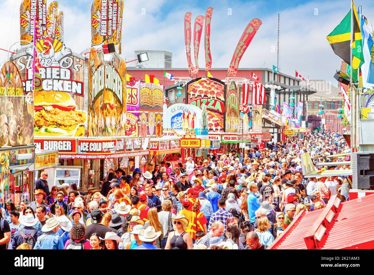 CALGARY, CANADA - July 9, 2019: A crowd filled the street during rush hour at the annual Calgary Stampede. The Calgary Stampede is often called the gr Stock Photo