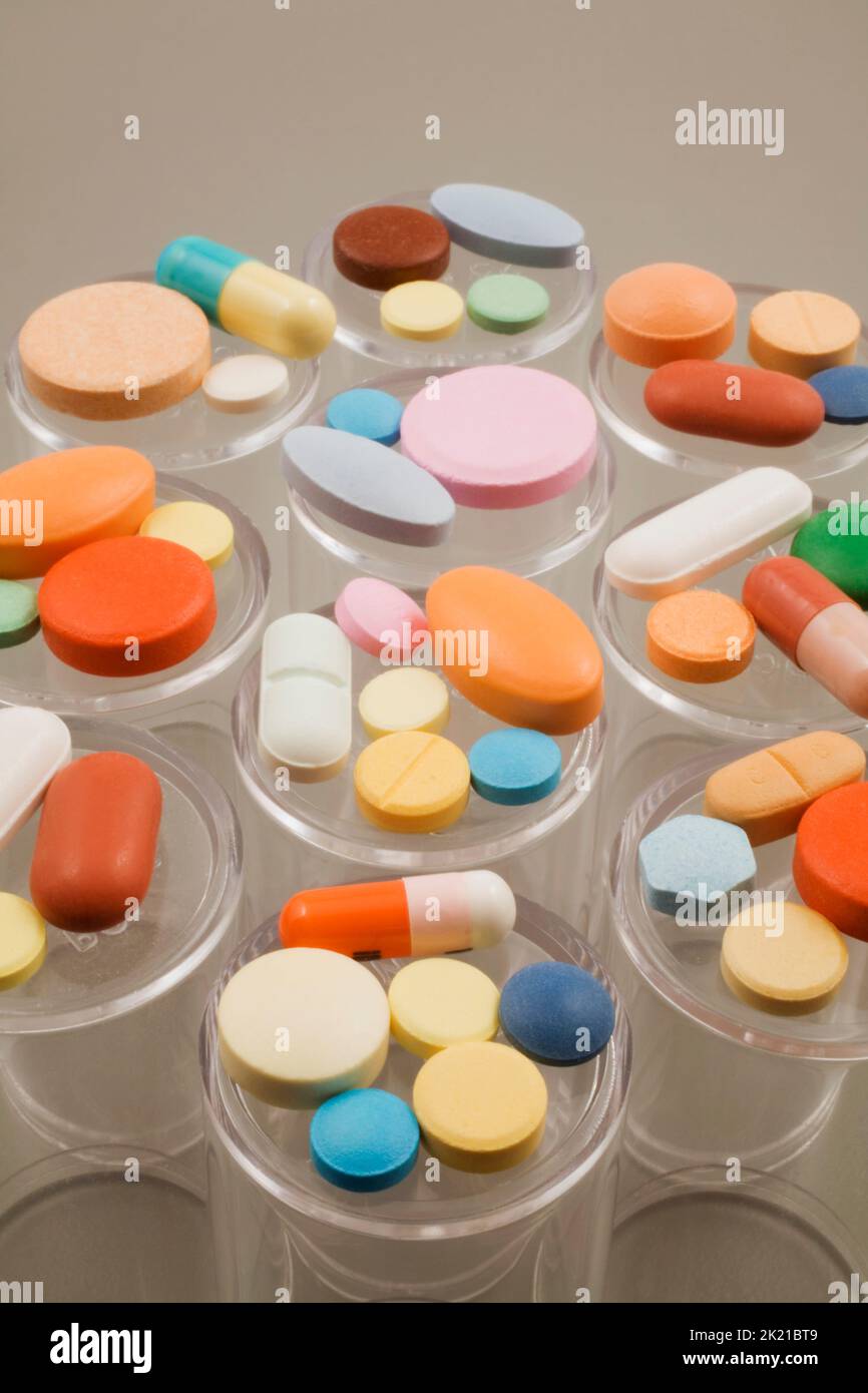 Close-up of assorted colored medicine pills on top of plastic pill bottles, Studio Composition, Quebec, Canada Stock Photo