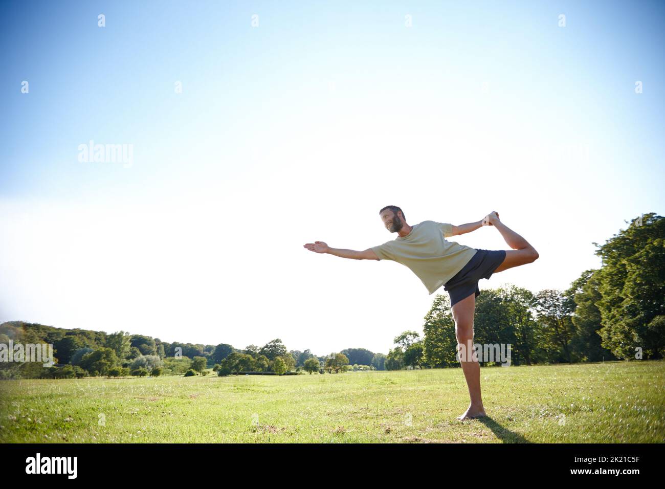 Perfect balance. Full length shot of a handsome mature man doing yoga outdoors. Stock Photo
