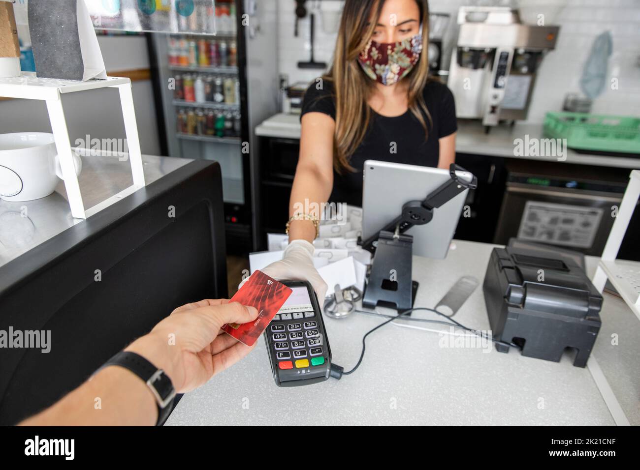 Customer paying by card in cafe during covid Stock Photo