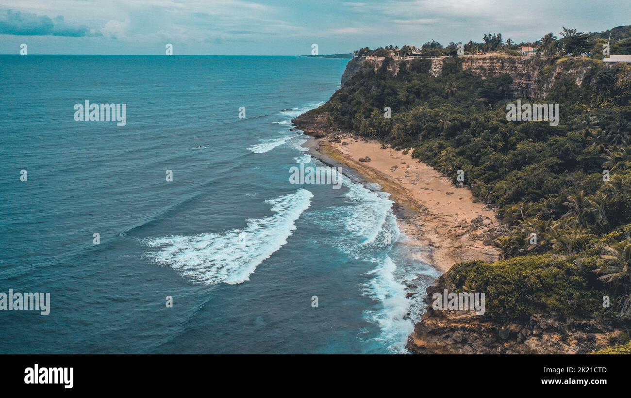 An aerial shot of an empty rocky beach with foamy waves Stock Photo - Alamy