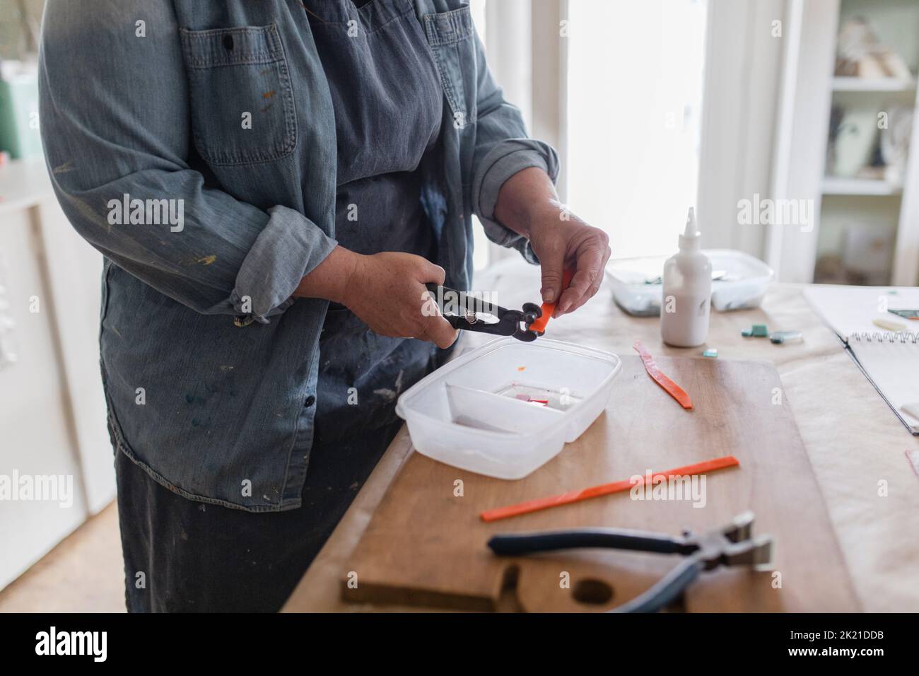 Female artist cutting glass for mosaics in art studio Stock Photo Alamy