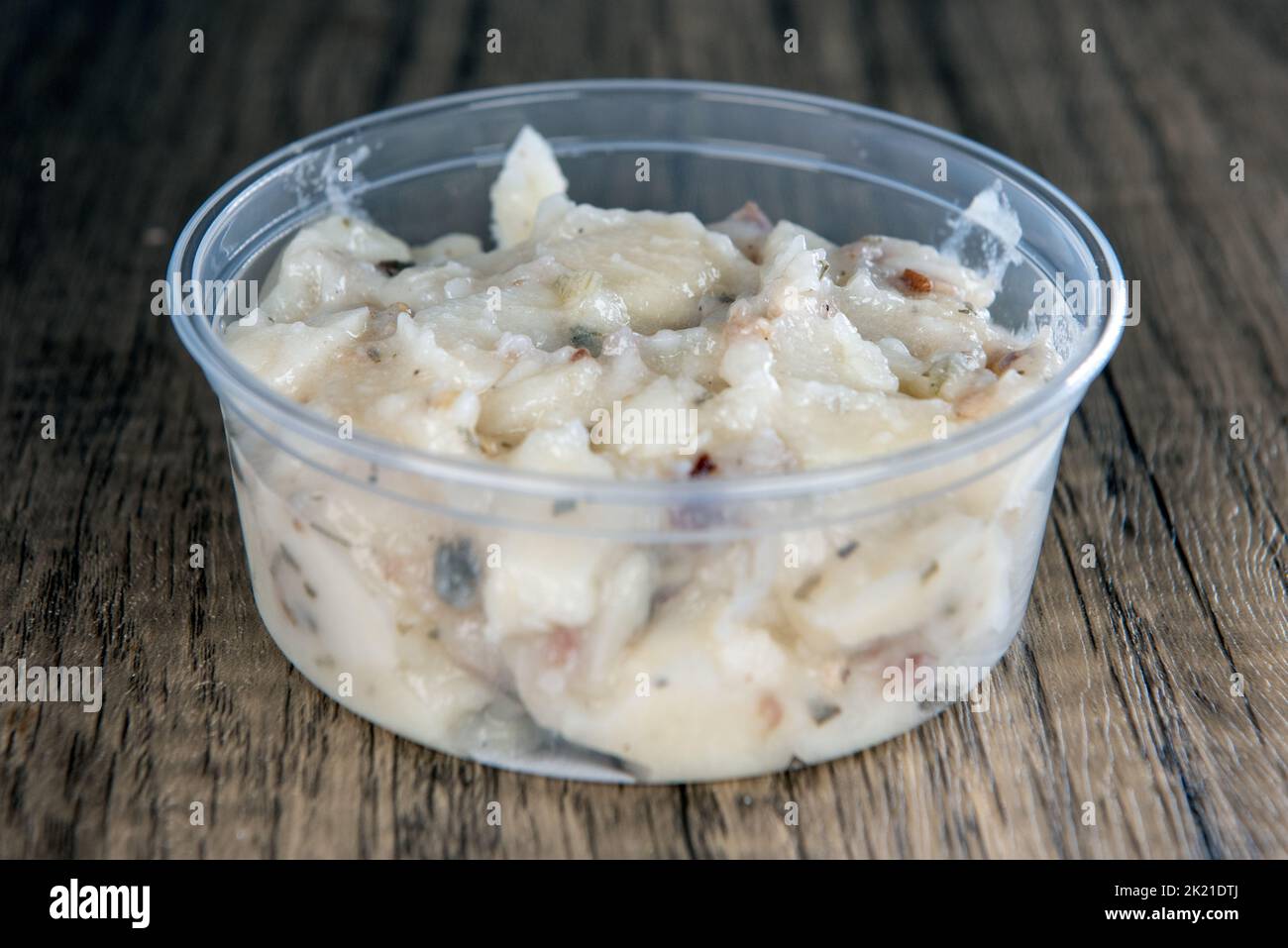 Lunch is complimented with a side order of  potato salad in a resuable container. Stock Photo