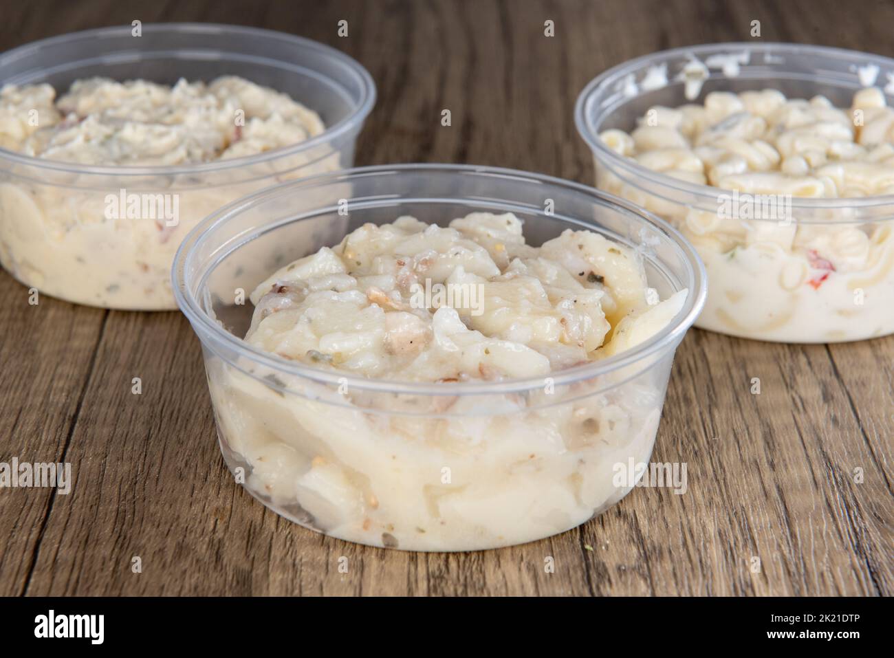 Lunch is complimented with a variety of side orders consisting of macaroni, potato, or German Potato salad in resuable containers. Stock Photo