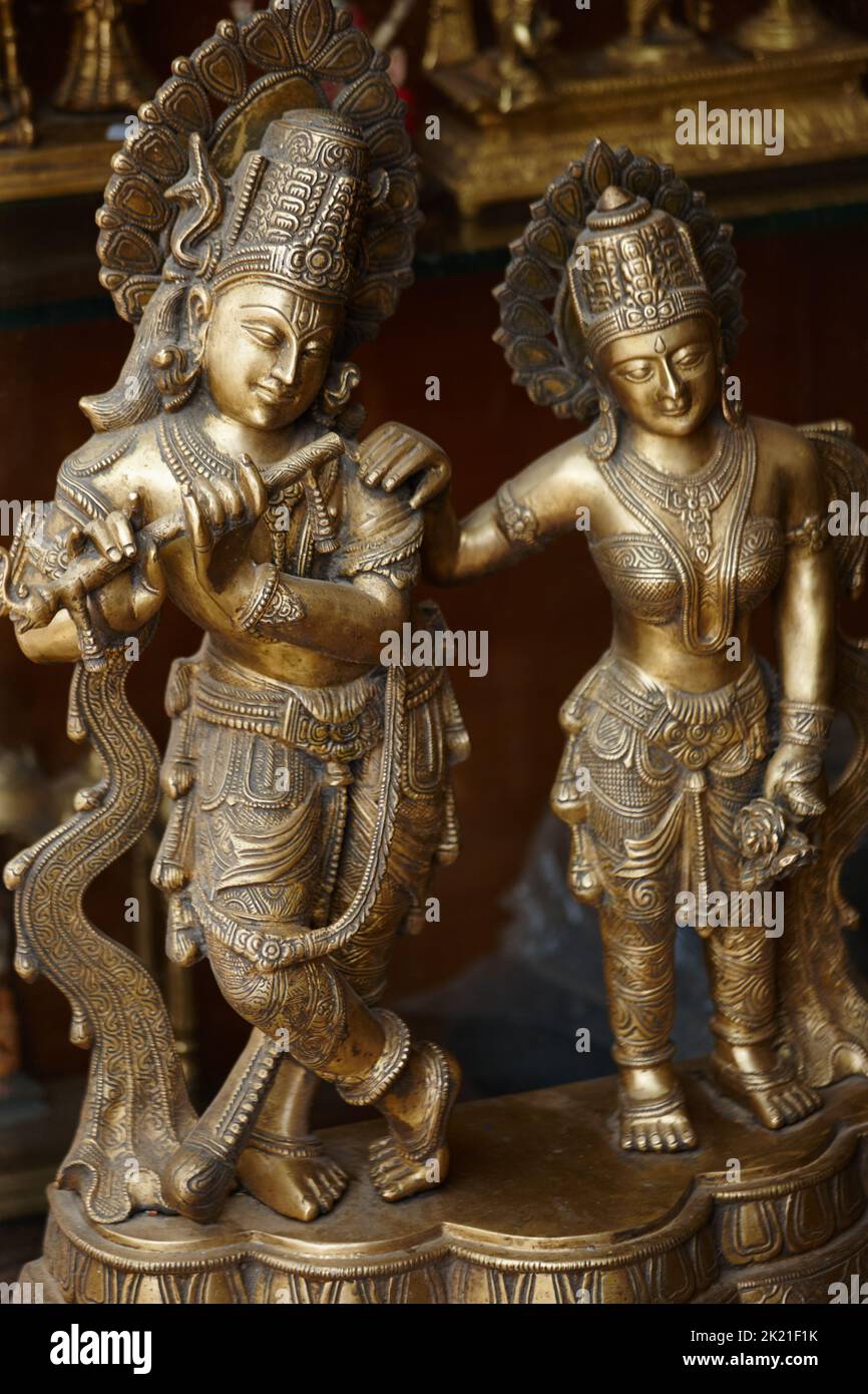 Krishna, the divine hero. Branze statue of the Hindu god Krishna with a companion in an Indian temple. Stock Photo