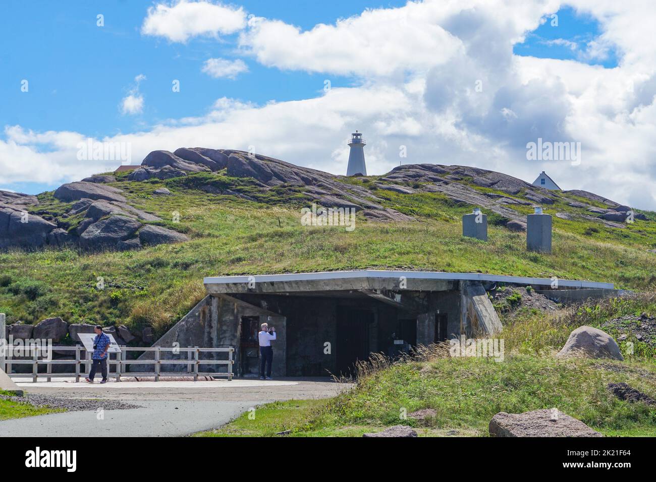 Cape Spear, Newfoundland, Canada: Lighthouse on the hill above the underground passages leading to bunkers built for troops stationed here during WWII. Stock Photo