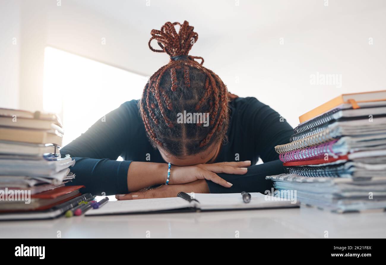 Stress, study and books with black woman sleeping at desk from burnout, tired or depression. Education, learning and knowledge with student rest at Stock Photo