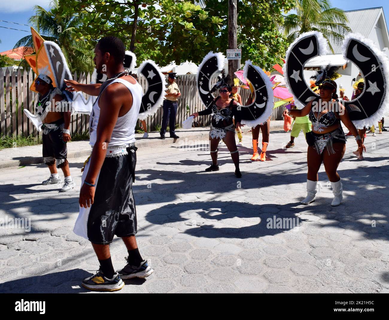 Dancers in elaborate black and white costumes parading in the San Pedro