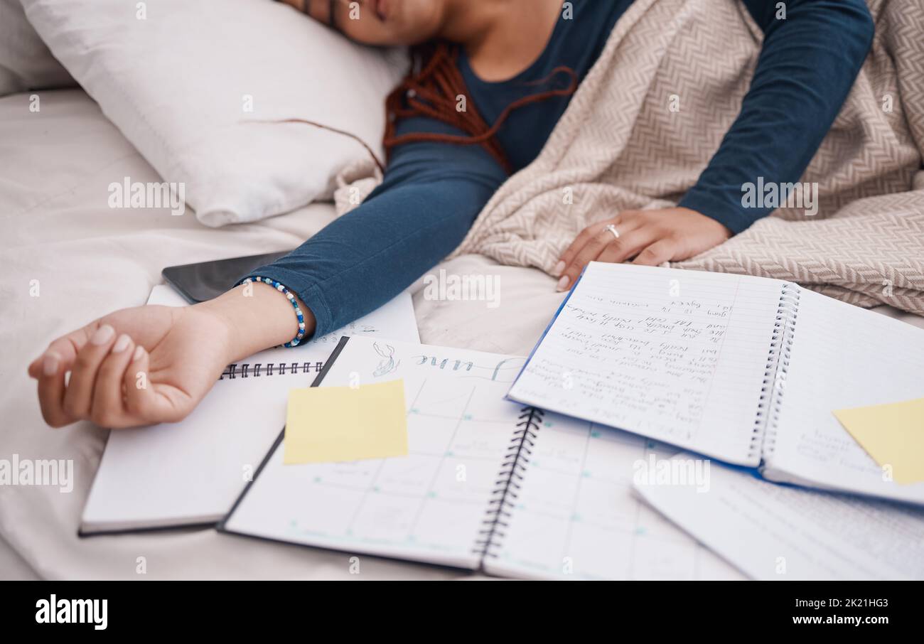 Calendar, time management and student sleeping in bed for studying education, learning knowledge and planning. Tired, burnout college university woman Stock Photo