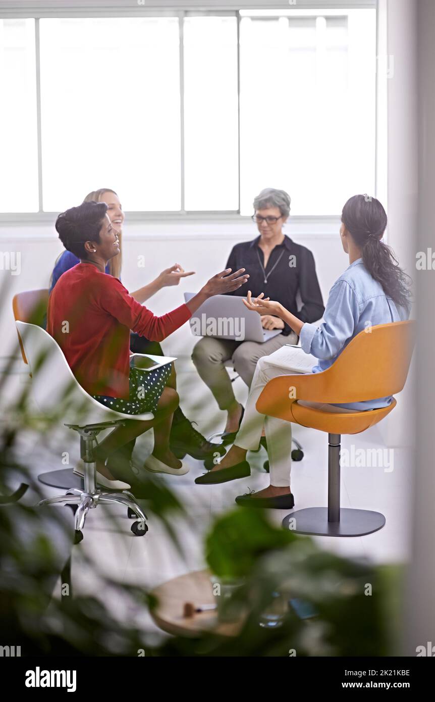 Coming up with a winning strategy. a group of female designers sitting in a creative meeting. Stock Photo