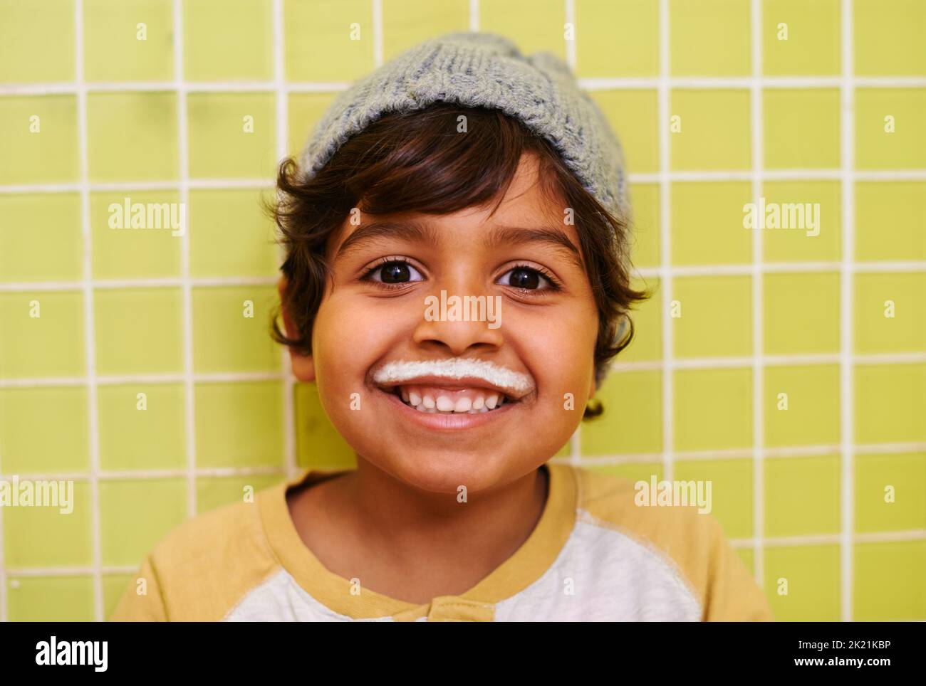 Hes got the milkshake moustache. a cute little boy with a milk moustache. Stock Photo