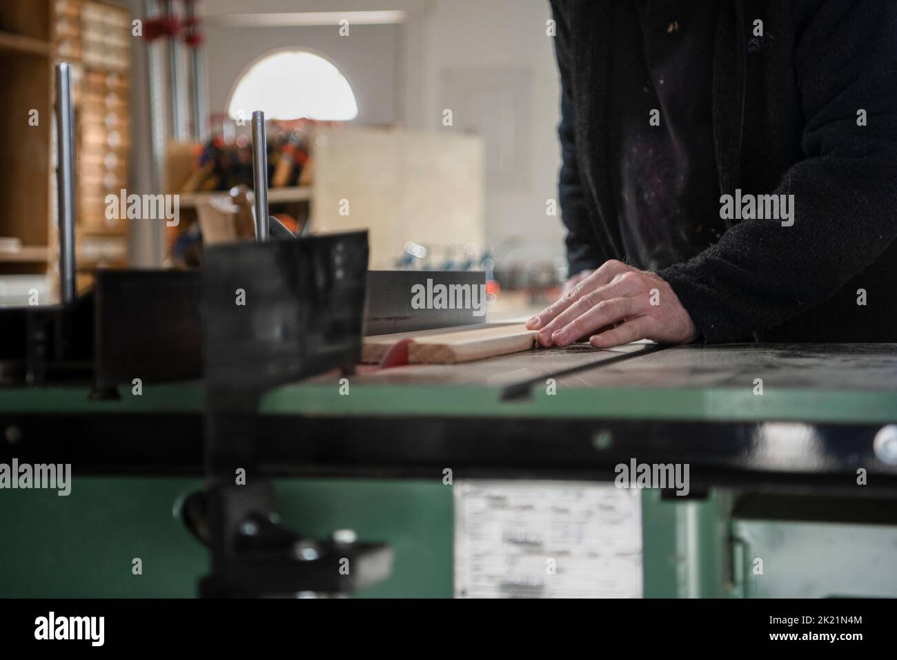 Male carpenter using table saw in workshop Stock Photo