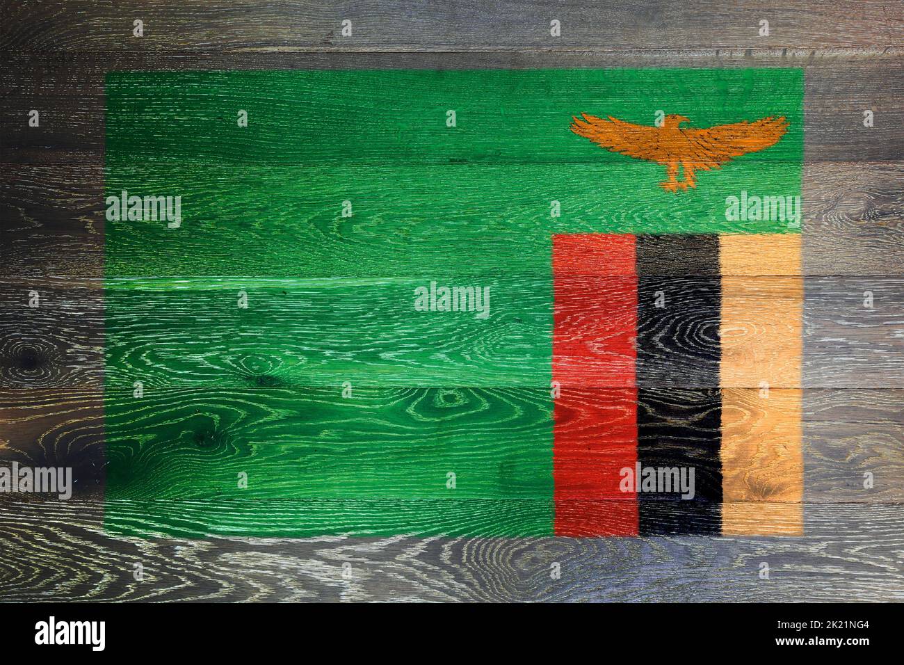 A Zambia flag on rustic old wood surface background Stock Photo