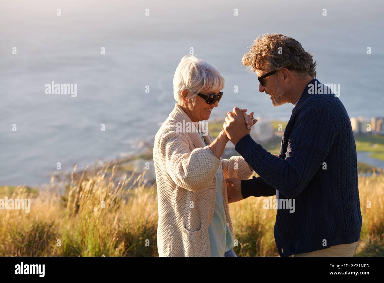 Shall we dance. Cropped view of a senior couple dancing on a hillside together. Stock Photo