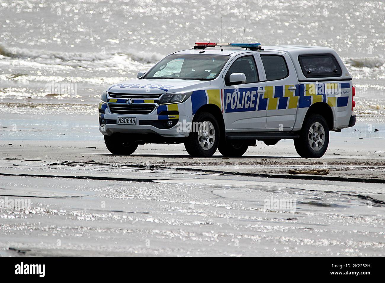 New Zealand police vehicle driving on beach Stock Photo