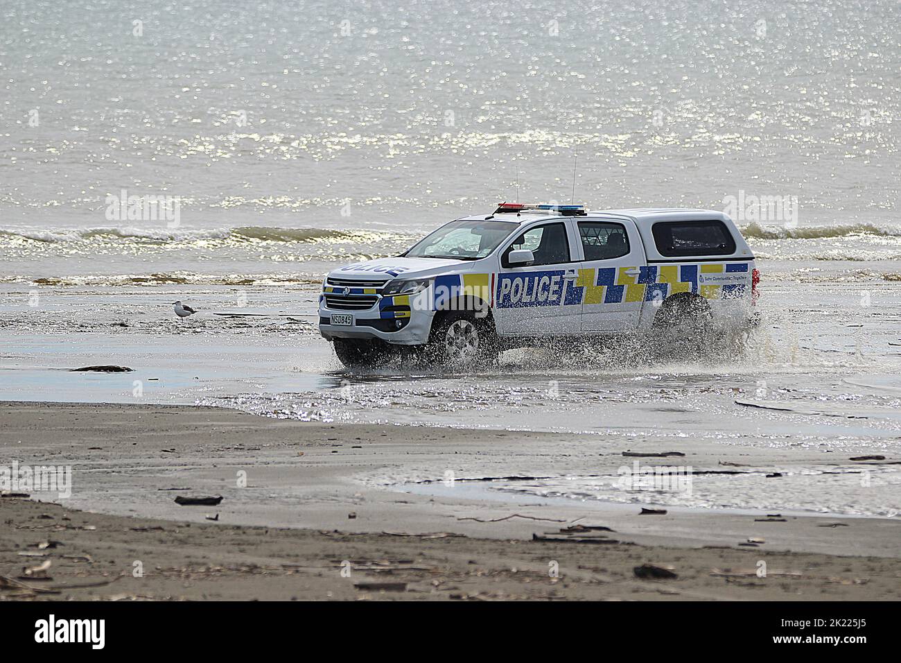 New Zealand police vehicle driving on beach Stock Photo