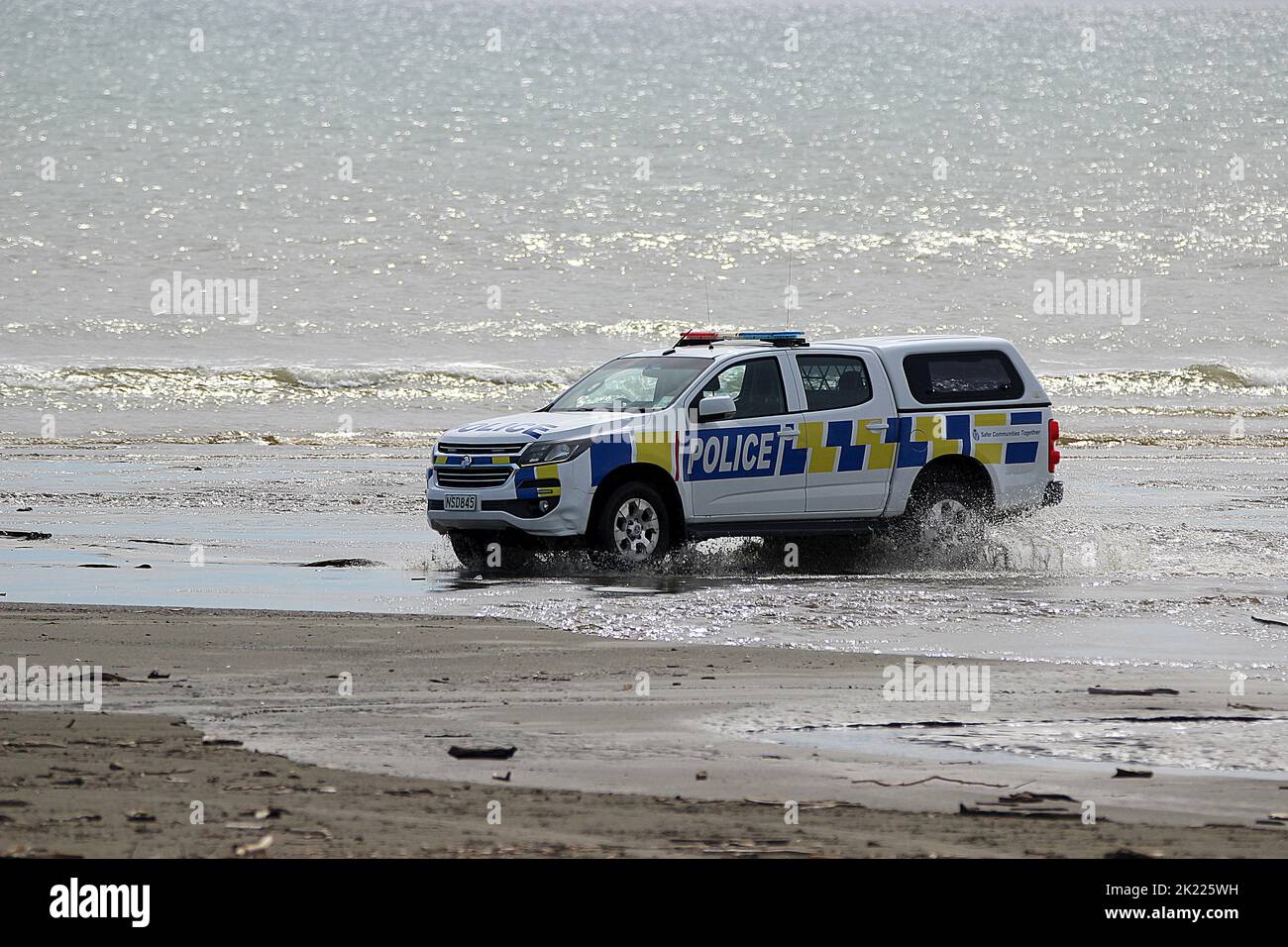 New Zealand police vehicle driving on beach Stock Photo