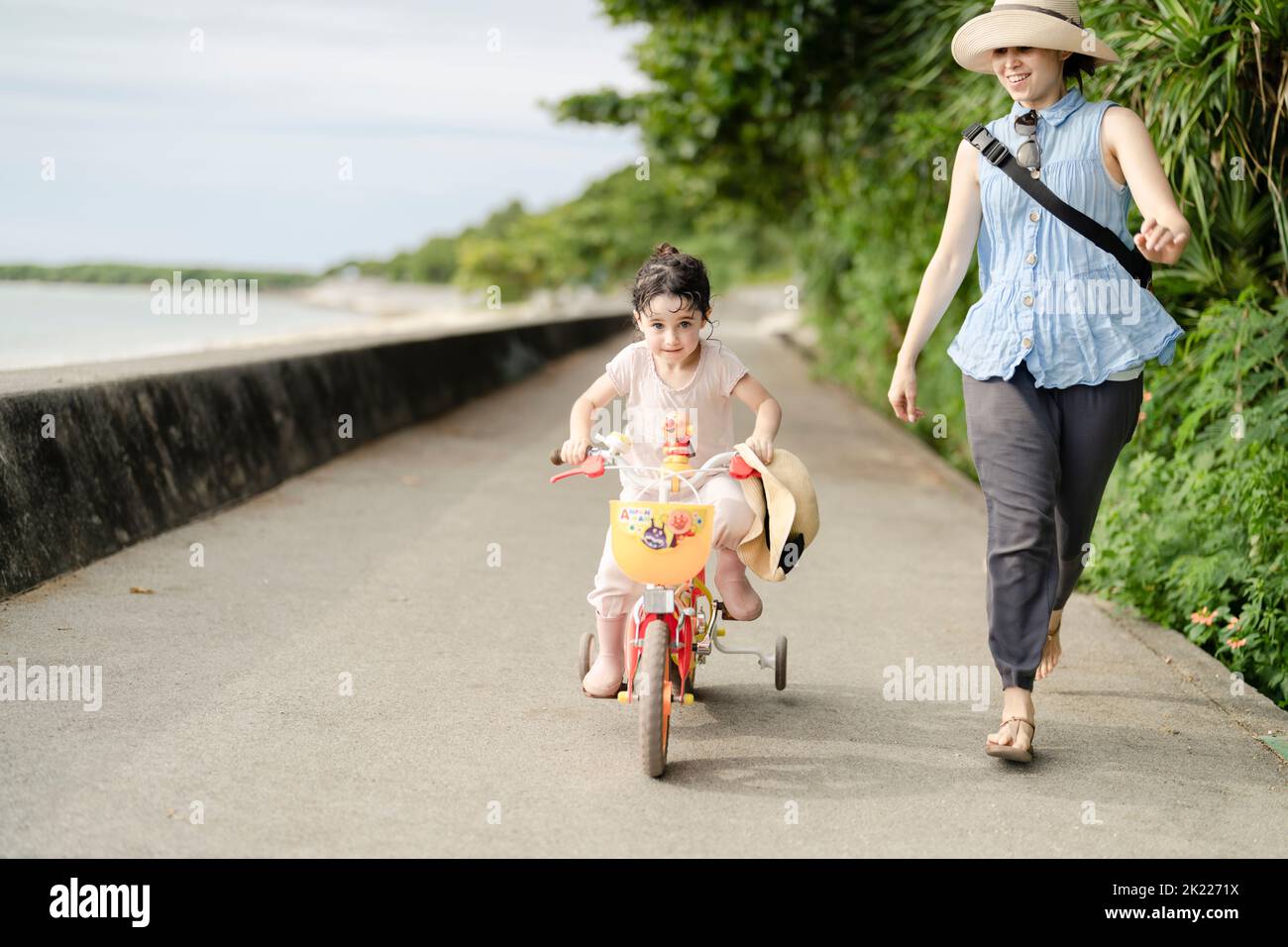 Mother and daughter - learning to ride a bicycle Stock Photo
