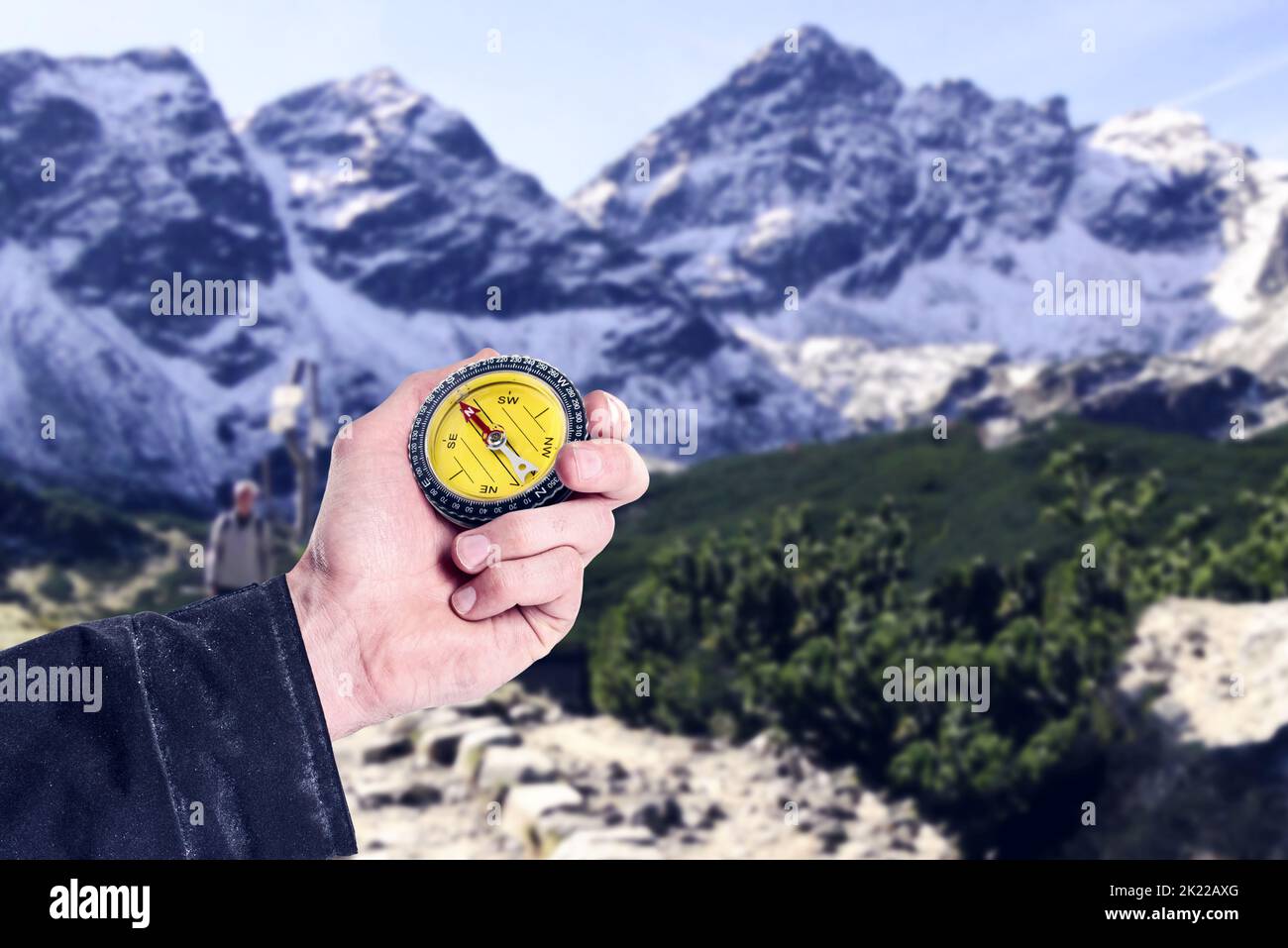 Hell always know where to go. a mans hand holding up a compass against extreme terrain. Stock Photo