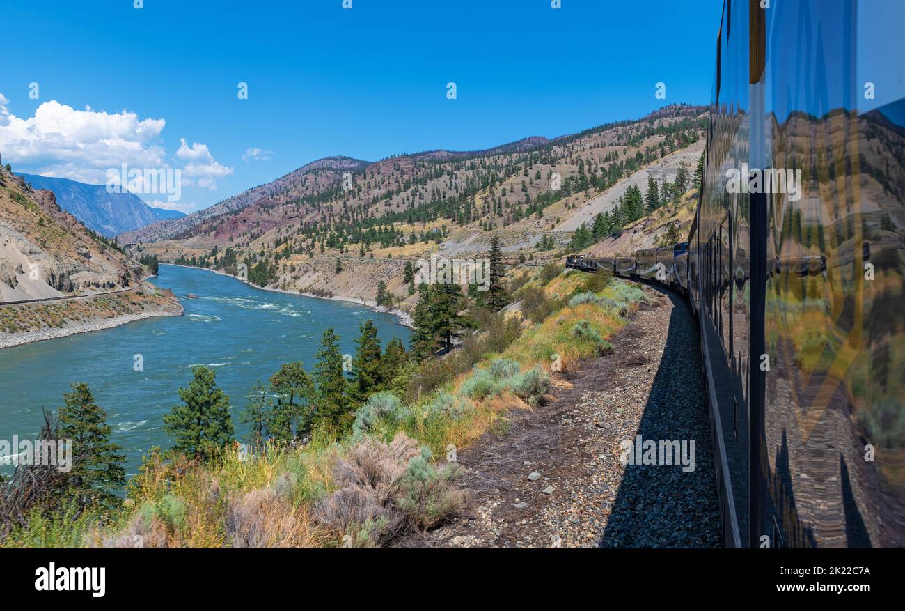 Rocky Mountaineer train riding along the Fraser River in British Colombia, Canada. Stock Photo