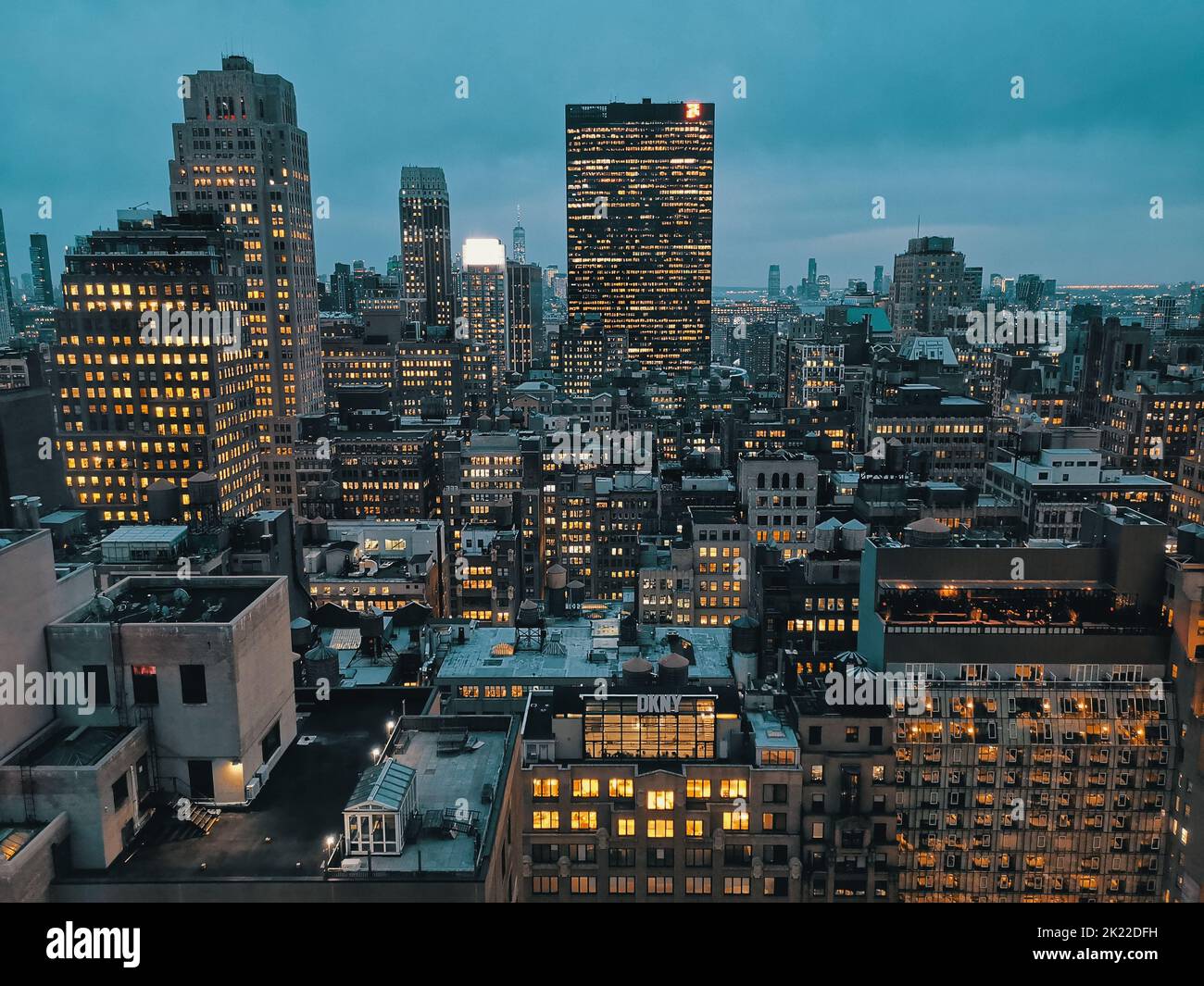 An aerial view of Manhattan, New York skyline illuminated at twilight ...