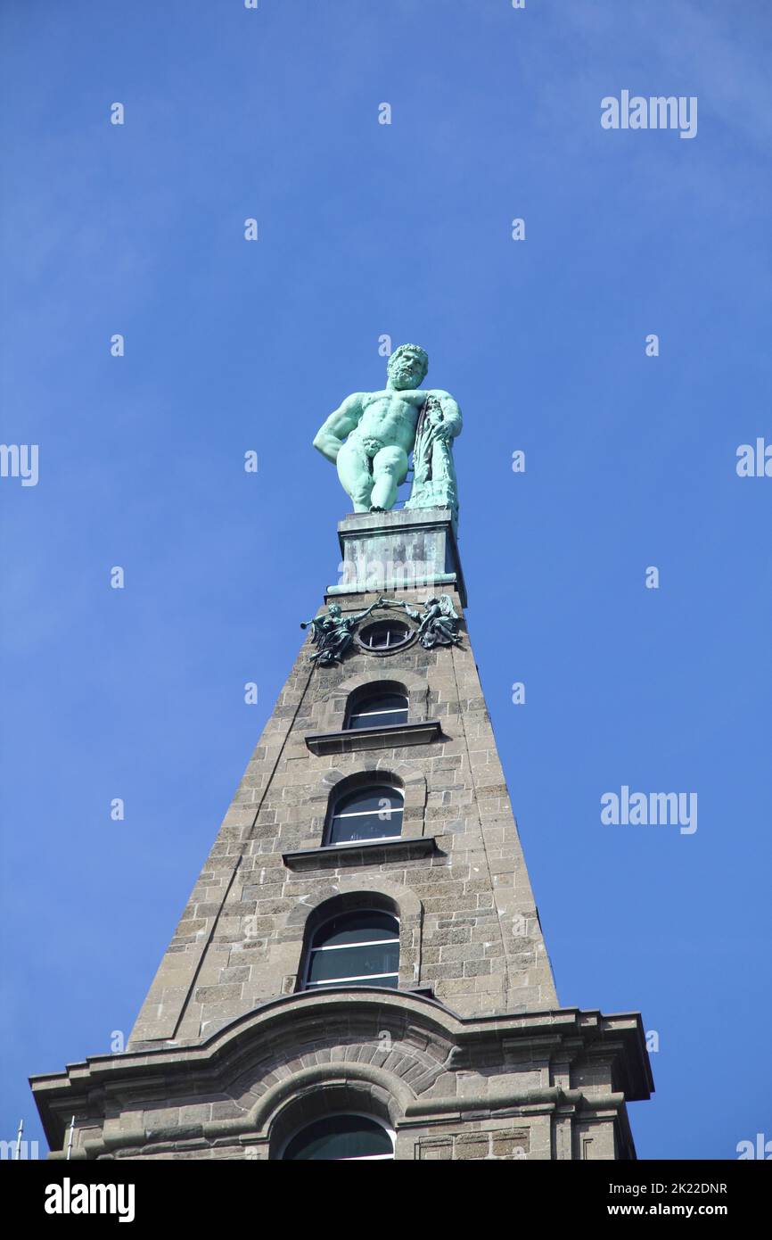 a Hercules statue with blue sky in the background Stock Photo