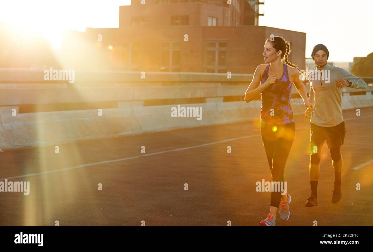 Nothing better than an A.M. run. two friends out jogging in the city in the early morning. Stock Photo