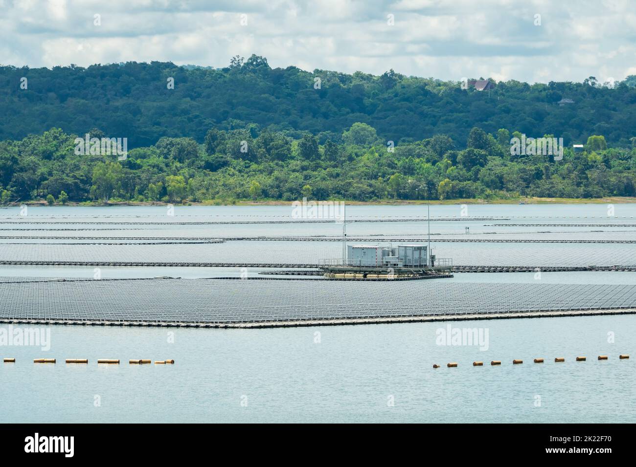 Floating solar farm or floating photovoltaics. Solar power. Landscape of solar panels floating on water in reservoir or lake. Solar technology. Stock Photo