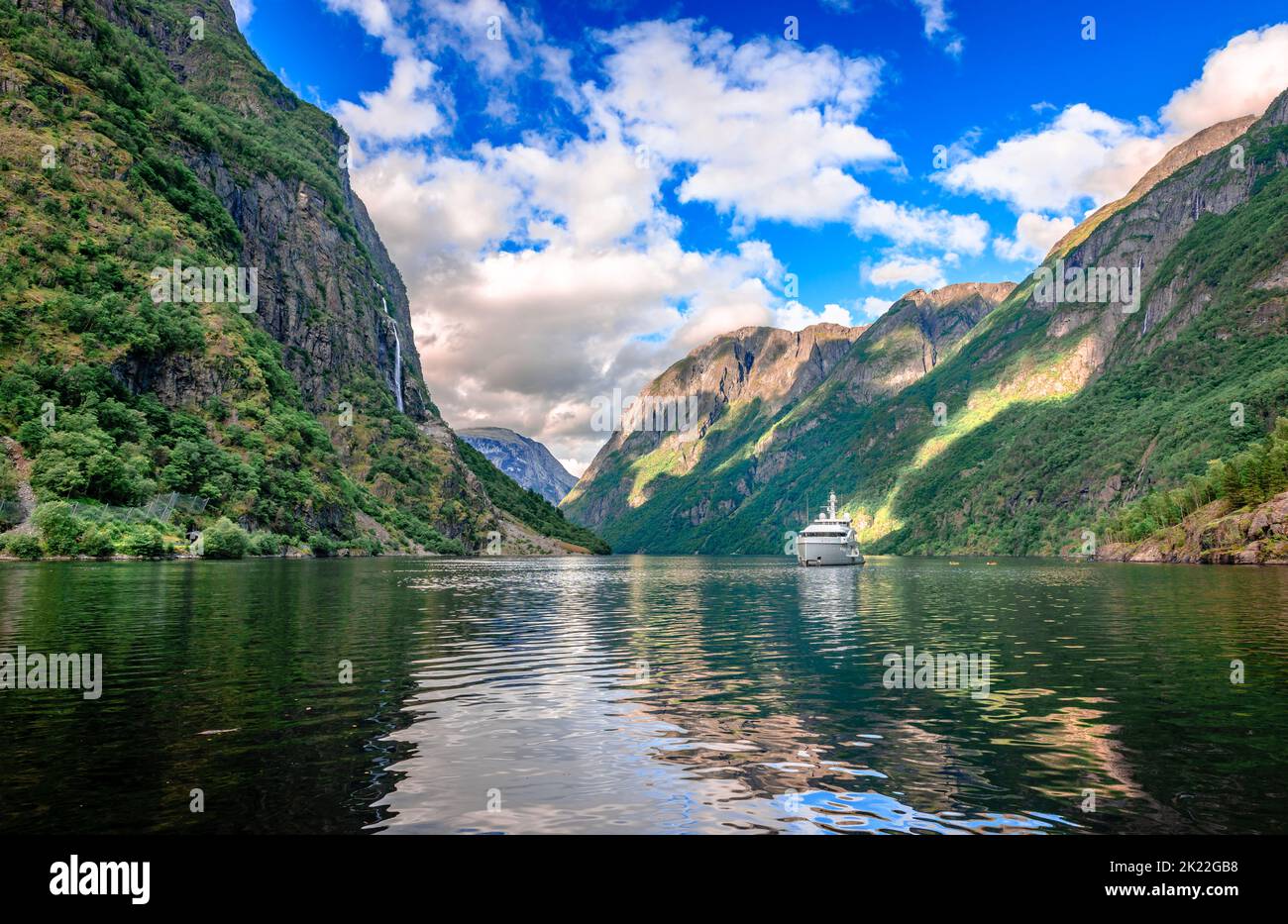 A tourboat sails in Aurlandsfjord, a branch off of the main Sognefjorden, Norway's longest fjord. Breathtaking Norwegian landscape. Stock Photo
