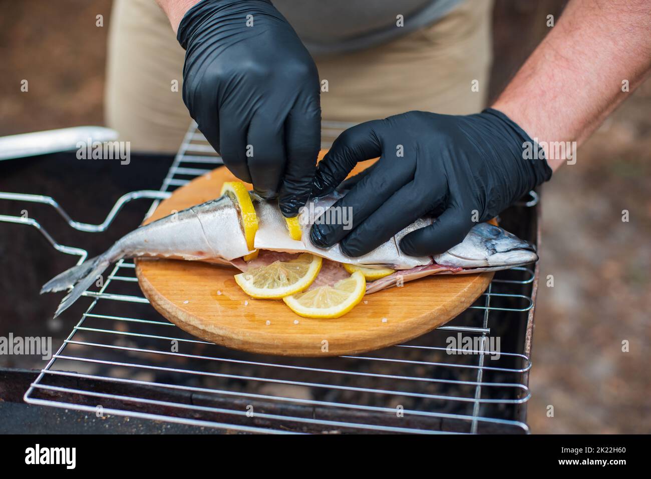 Grilled mackerel fish with lemon slices, top view. The process of