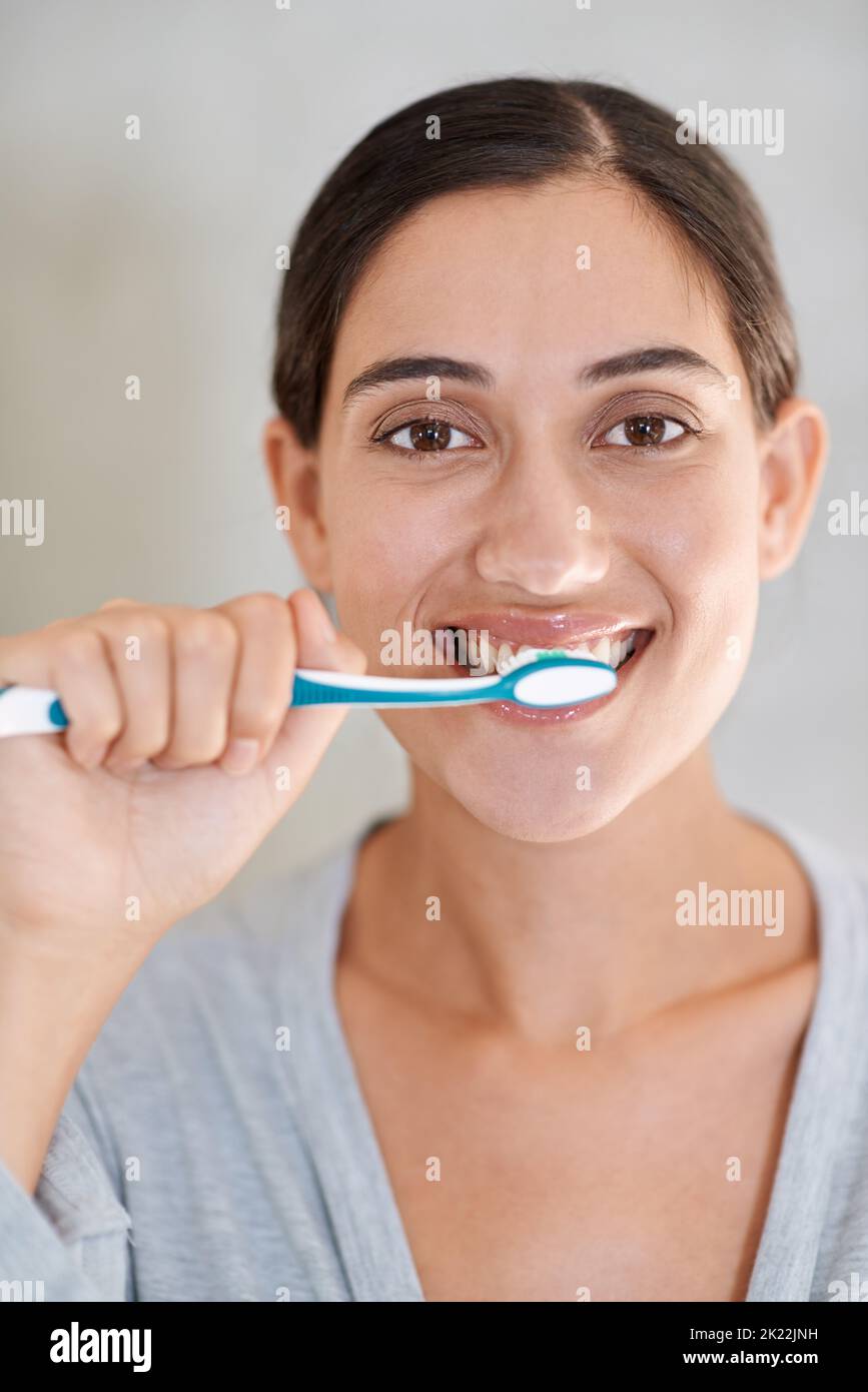 I brush three times a day portrait of an attractive young woman
