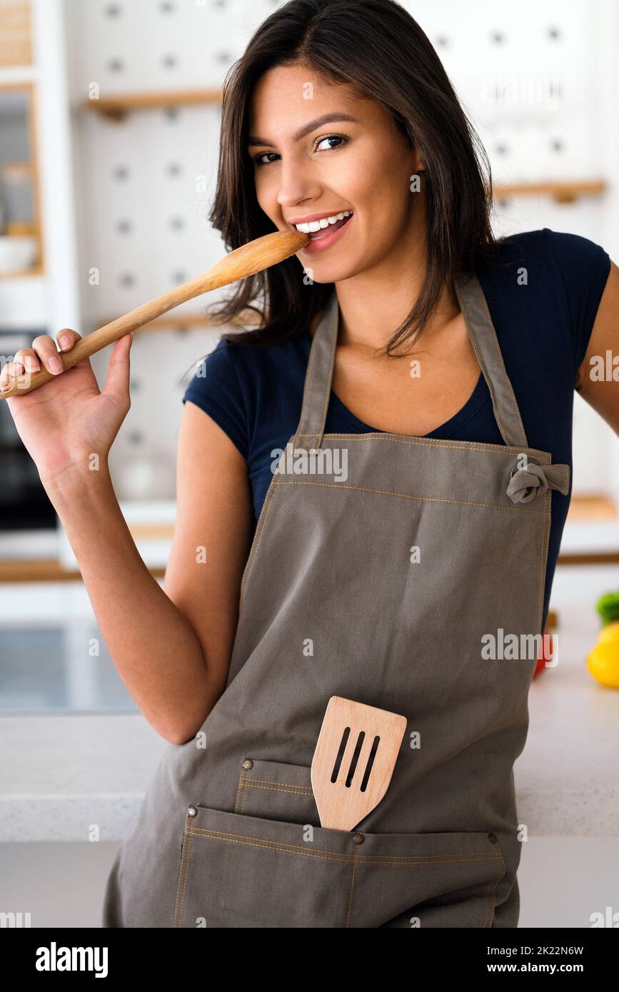 Beautiful young woman cooking in the kitchen. Healthy, organic, food concept Stock Photo