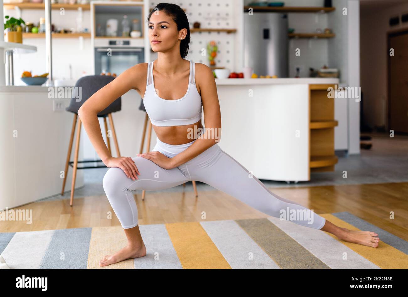 Fit sport woman exercising and training at home Stock Photo
