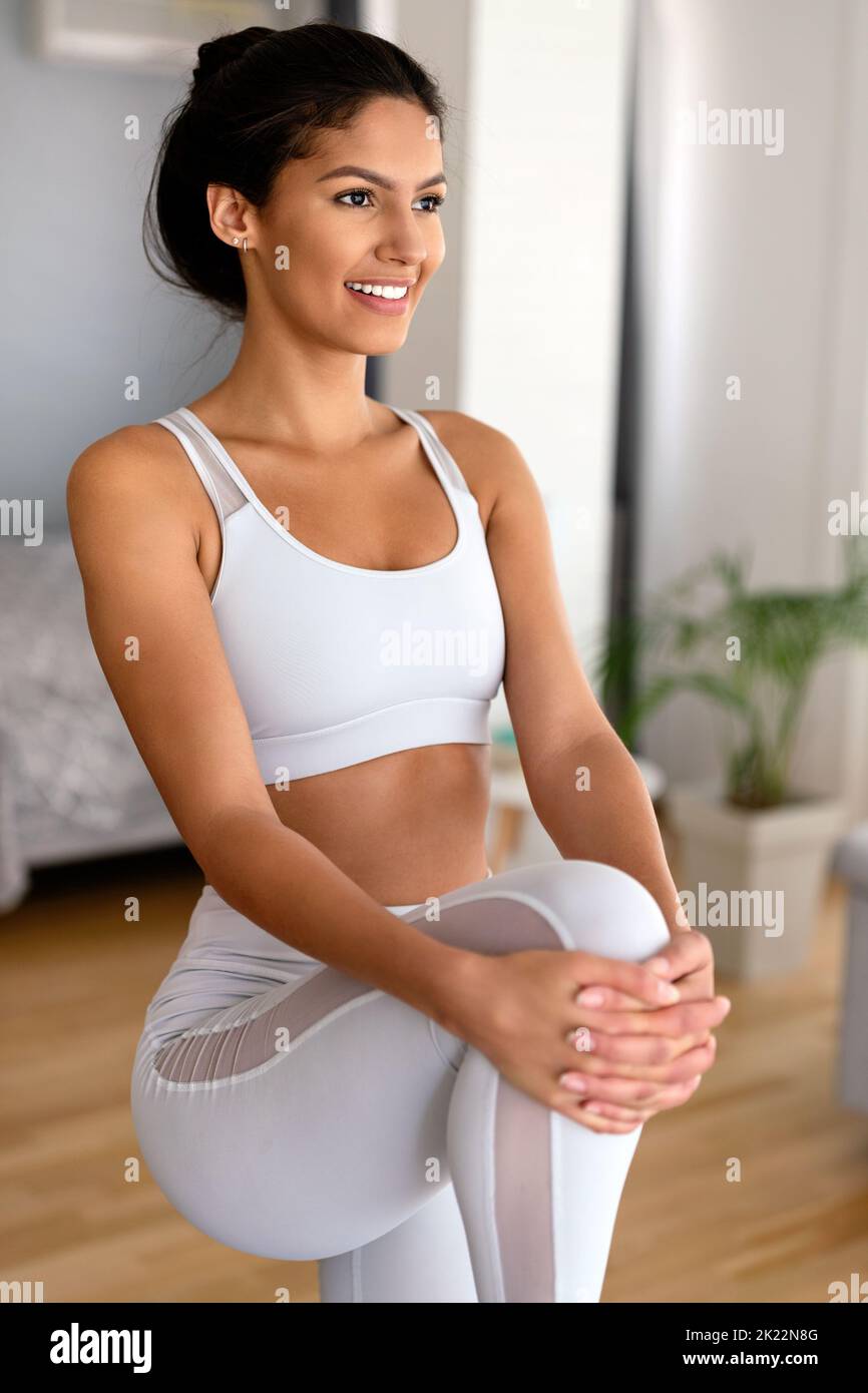 Happy fit young woman exercising at home. Healthy lifestyle, people, sport concept Stock Photo