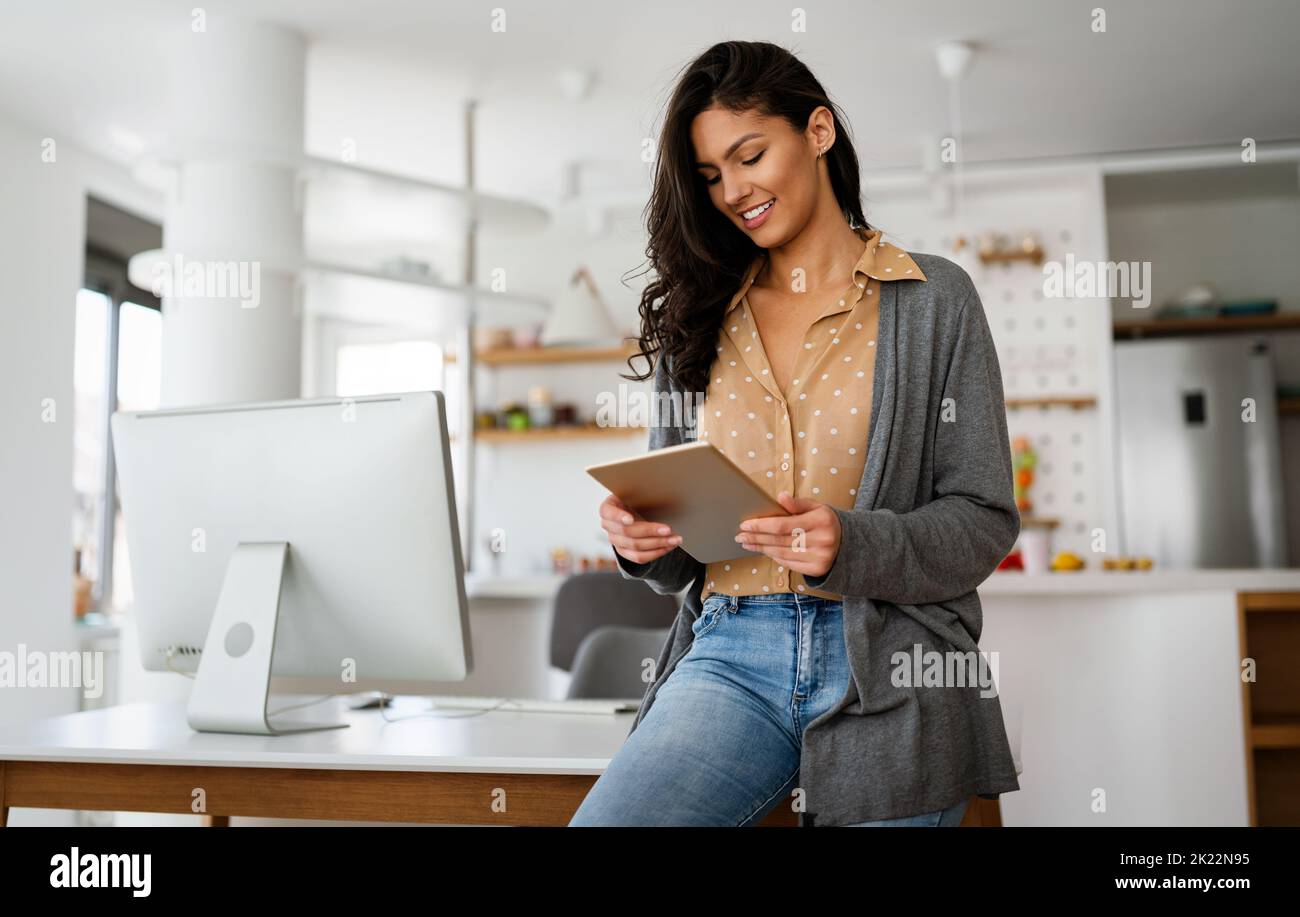 Beautiful young woman with digital tablet at home Stock Photo