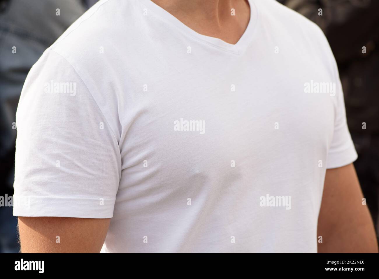 Unrecognizable man dressed white t-shirt. Template for your design. Half-turn. Closeup Stock Photo