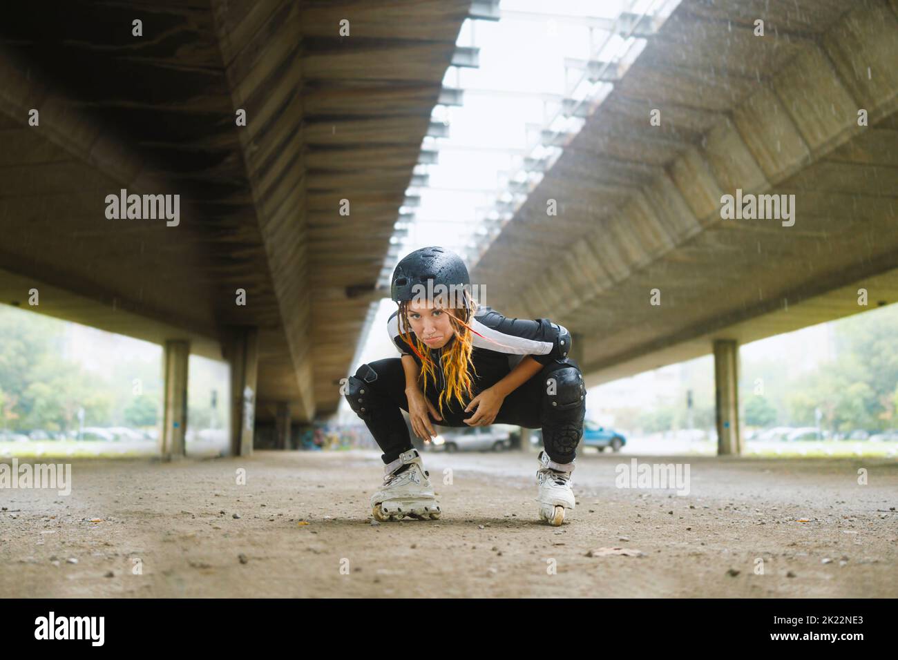 Young active woman wearing roller blades and protection gear Stock Photo