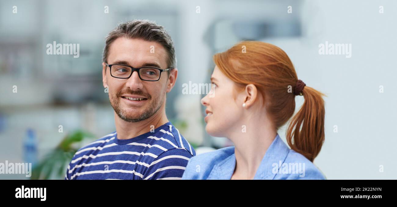 Im so glad were partners. two coworkers in an office setting. Stock Photo