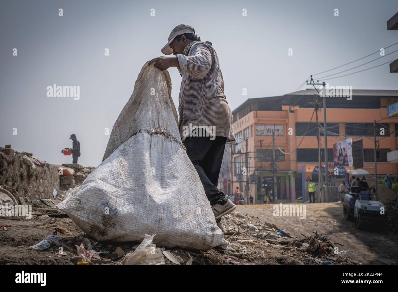 A man collecting rubbish from the streets of Kathmandu, Nepal Stock