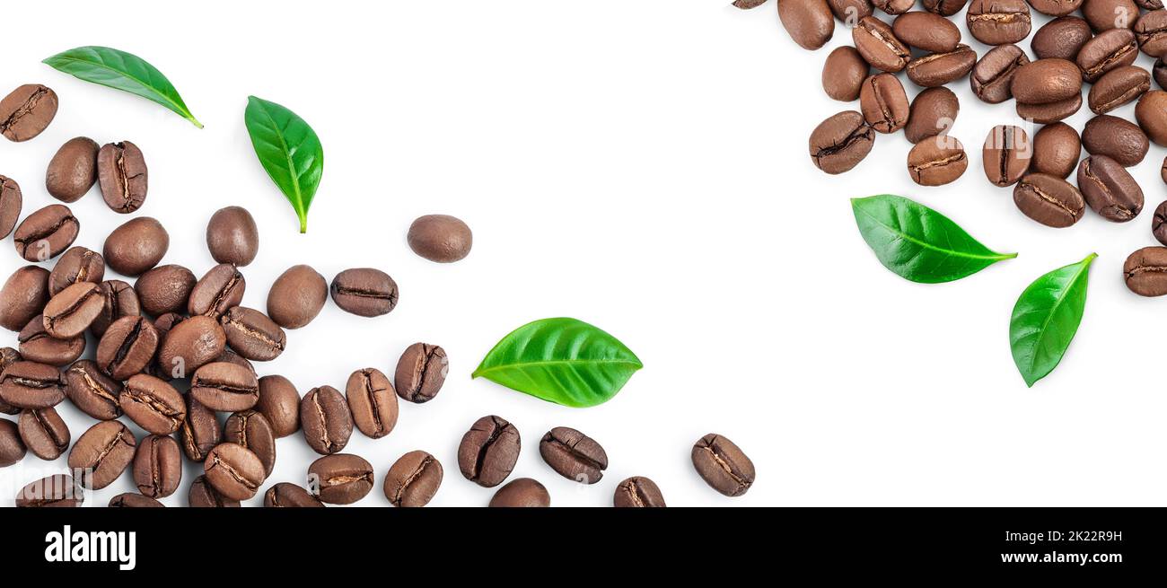Heap of roasted coffee beans with leaves isolated on white background ...