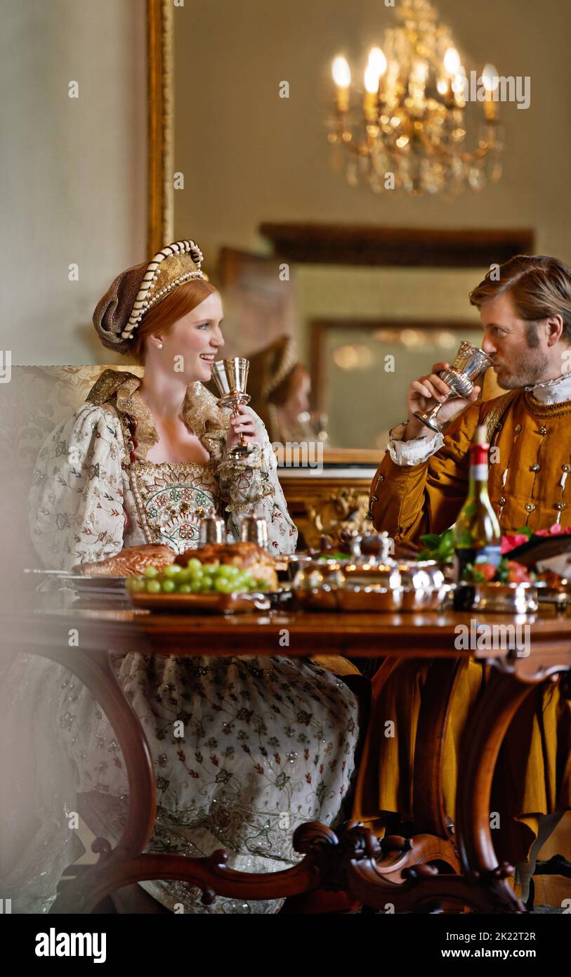 Living the life of the nobility. A regal king and queen enjoying a meal together. Stock Photo