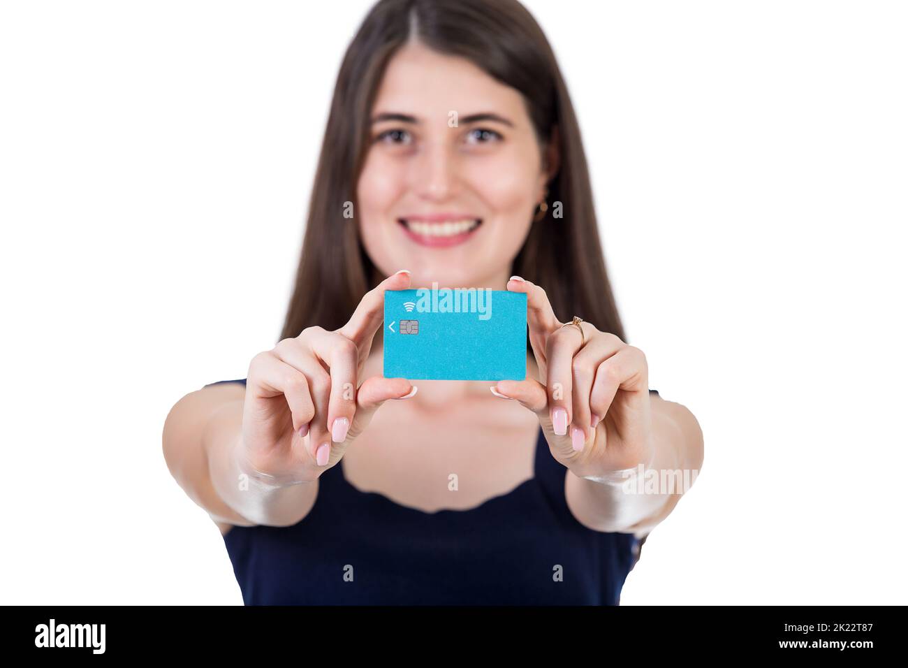 Close up portrait of a young woman with hands outstretched to camera, presenting a credit card. Girl advertising her favorite bank, financial concept Stock Photo